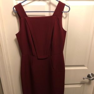 Below the knee, burgundy dress.